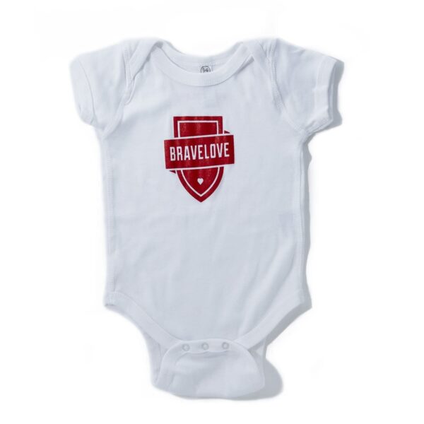 Product Description: White Baby Onesie featuring a red "BRAVELOVE" shield logo on the front.