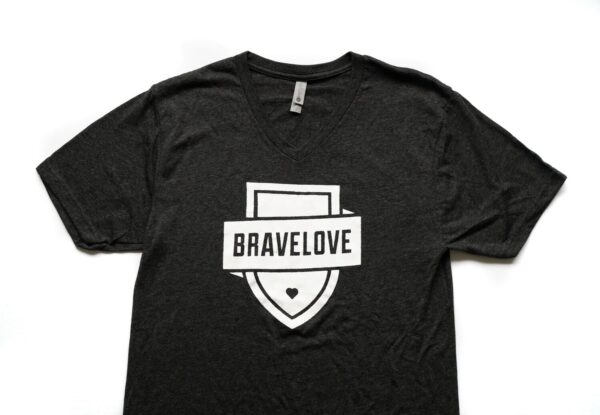 Black V-Neck T-Shirt with a white shield design and the word "BRAVELOVE" across it, featuring a small heart at the bottom.