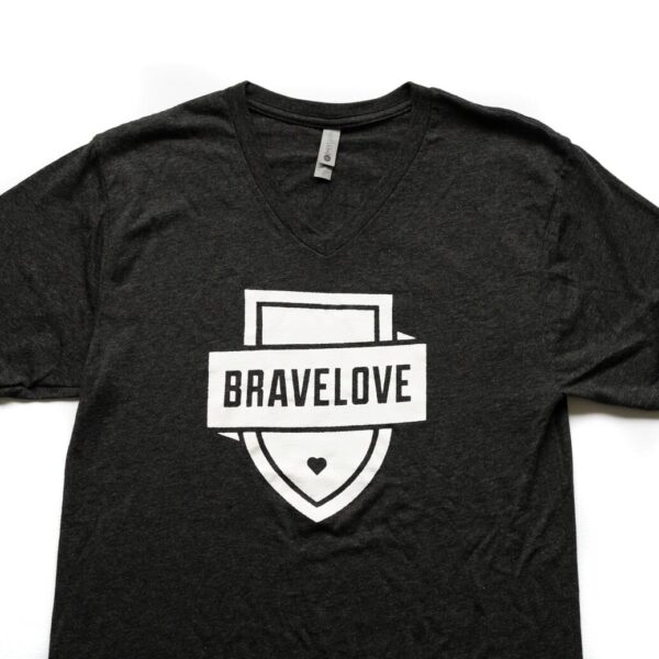 Black V-Neck T-Shirt with a white shield design and the word "BRAVELOVE" across it, featuring a small heart at the bottom.