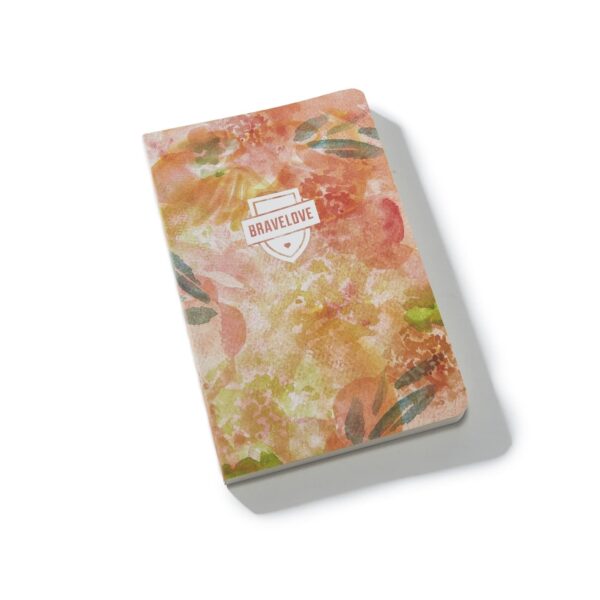 A BraveLove Journal featuring a closed floral print cover with the "Bravelove" logo, placed against a white background.