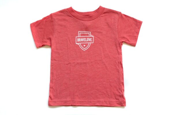 A red "New! Toddler T-Shirt" with short sleeves featuring a white "Bravelove" logo in the center on a plain background.