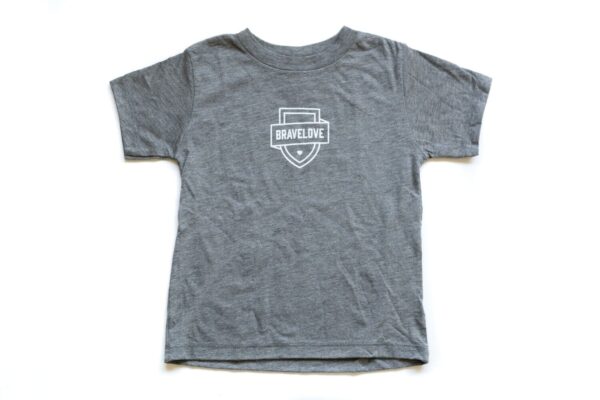 New! Toddler T-Shirt in Grey with a white "BraveLove" logo at the center, featuring a stylized shield design with text across the middle.