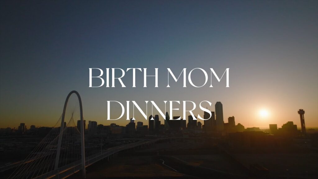 A city skyline at sunset with the words "Birth Mom Dinners" in large white font overlaying the image.