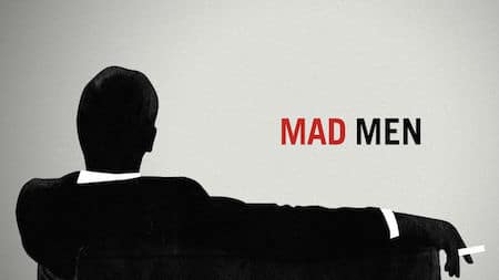 Silhouette of a man in a suit sitting with one arm draped over the back of a chair, with the title "Mad Men" in red and black text.