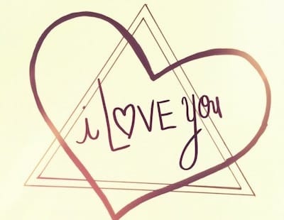 A hand-drawn heart and triangle outline with "I love you" written inside, where the "o" in "love" is replaced by a heart symbol.