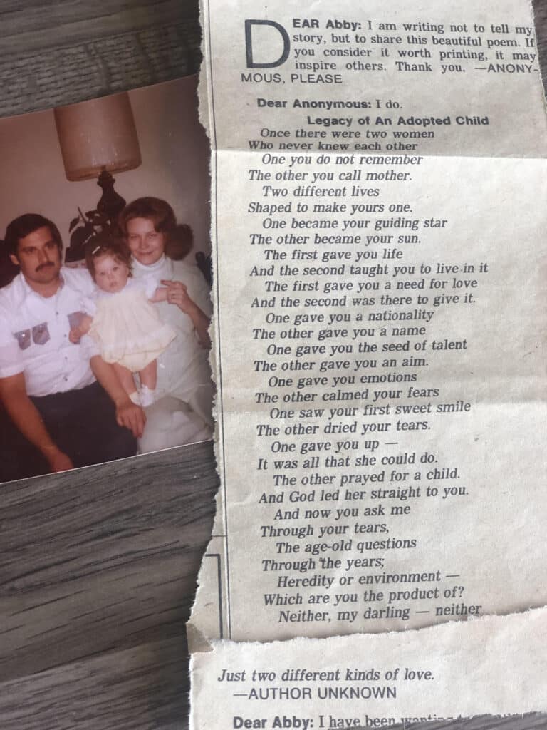 Old newspaper clipping with a poem titled "Legacy of An Adopted Child" and a faded photo of a family with a man, woman, and baby.