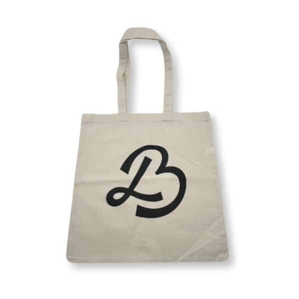 Tan New logo! tote bag featuring a prominent black letter "B" design on the front.